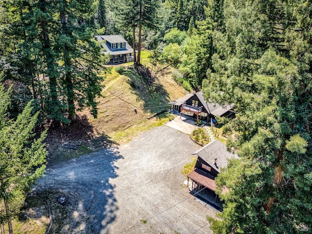 bird's eye view with a wooded view