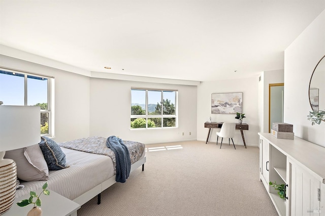 bedroom featuring carpet and multiple windows