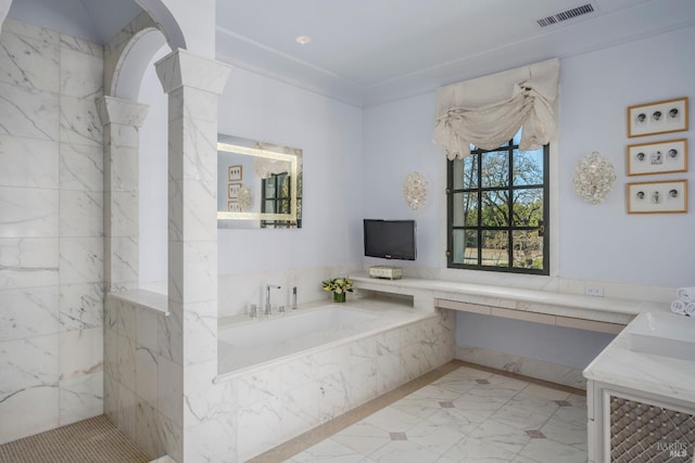 bathroom with a washtub, sink, and tile floors