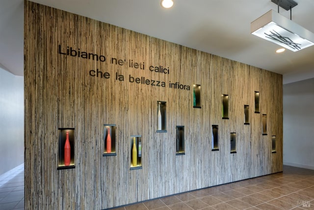 interior space featuring tile flooring and wooden walls