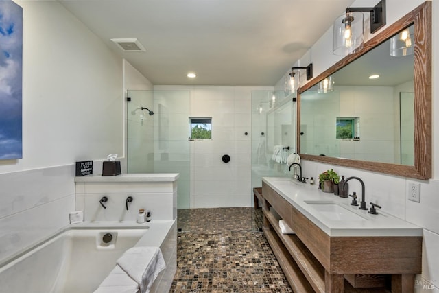 bathroom featuring tile floors, tile walls, dual vanity, backsplash, and separate shower and tub