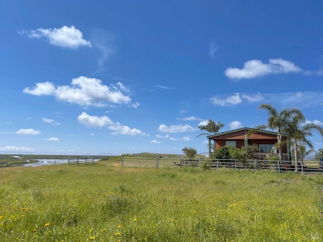 view of yard featuring a water view and a rural view