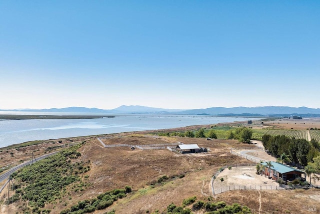 aerial view with a water and mountain view and a rural view