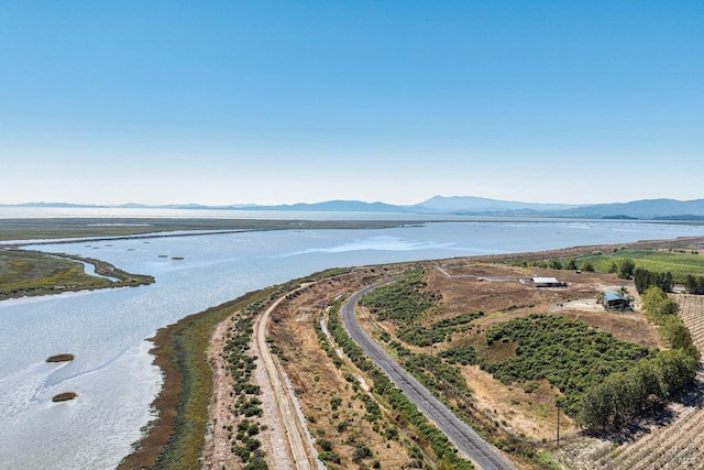 birds eye view of property featuring a water and mountain view