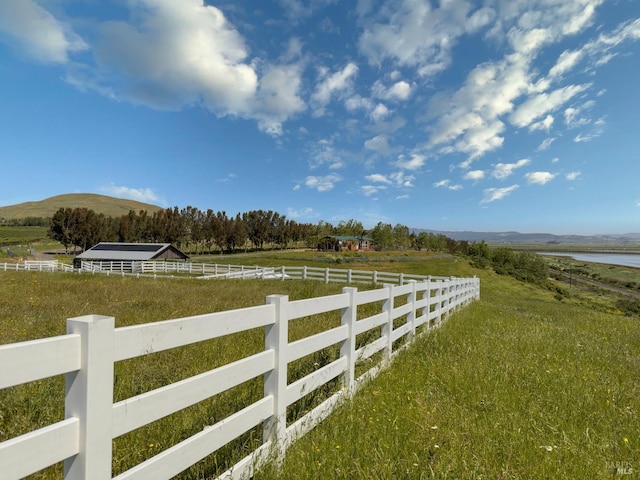 view of yard featuring a mountain view and a rural view