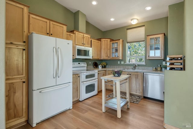 kitchen featuring light brown cabinets, sink, light hardwood / wood-style floors, and white appliances