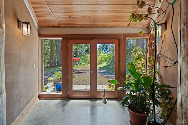 doorway to outside with french doors, wooden ceiling, and concrete floors