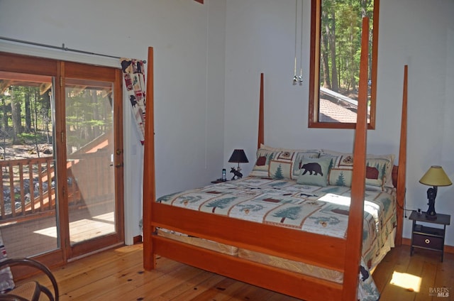 bedroom featuring hardwood / wood-style floors and access to outside