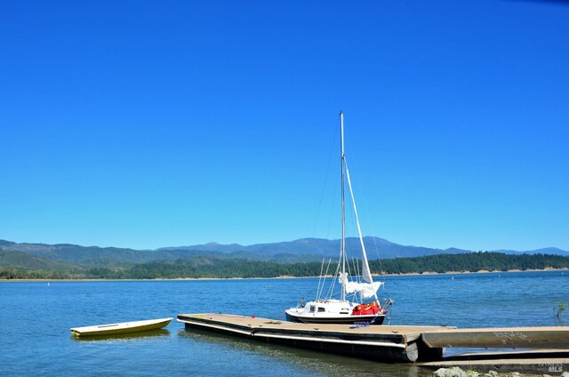 view of dock with a water and mountain view