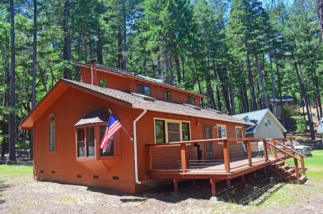 back of house featuring a wooden deck