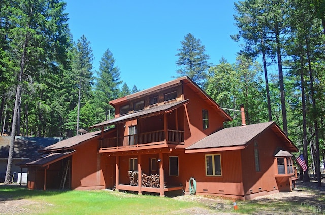 rear view of property featuring a balcony