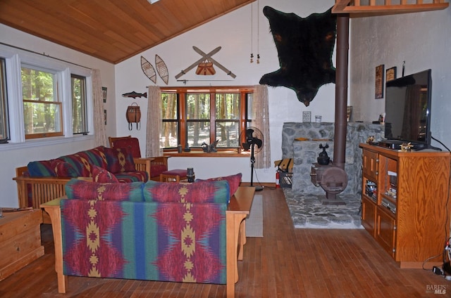 living room featuring hardwood / wood-style flooring, lofted ceiling, a wood stove, and wooden ceiling