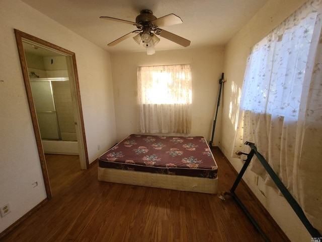 bedroom with ceiling fan and dark hardwood / wood-style flooring