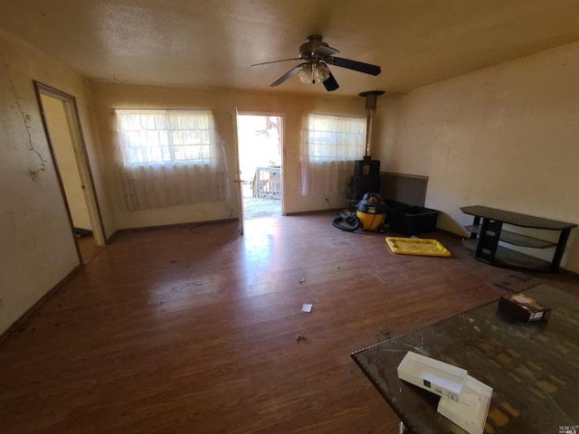 interior space with ceiling fan and wood-type flooring