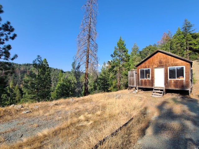 view of front of house featuring a storage shed