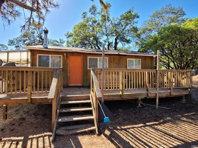 back of property featuring a wooden deck