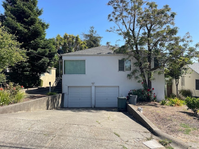 view of home's exterior featuring driveway, an attached garage, and stucco siding