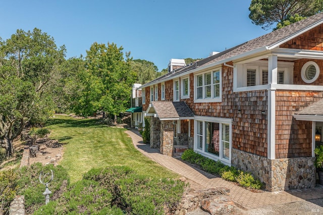 view of side of home with a lawn