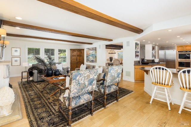 living room featuring beam ceiling and light wood-type flooring