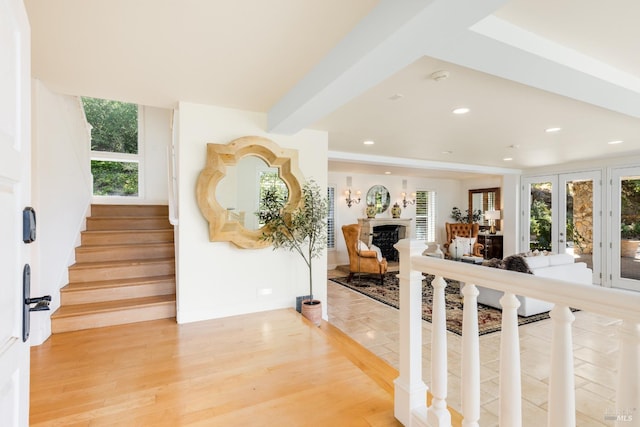 entrance foyer featuring french doors, a wealth of natural light, and hardwood / wood-style flooring