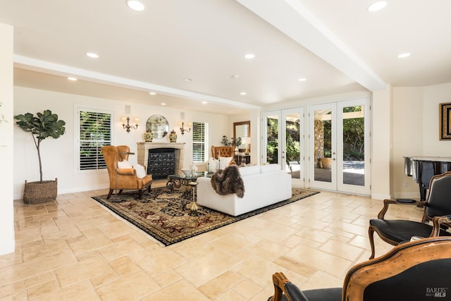 living room with french doors, a wealth of natural light, and beam ceiling