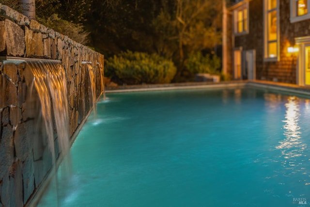 view of swimming pool featuring pool water feature