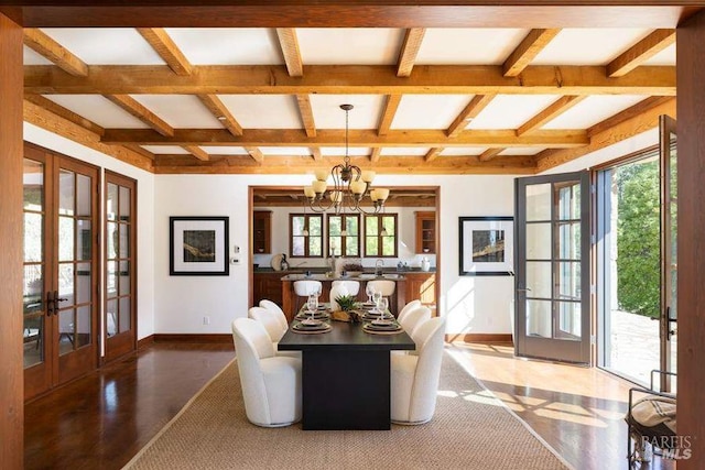 living room featuring french doors, beamed ceiling, wood-type flooring, a notable chandelier, and coffered ceiling