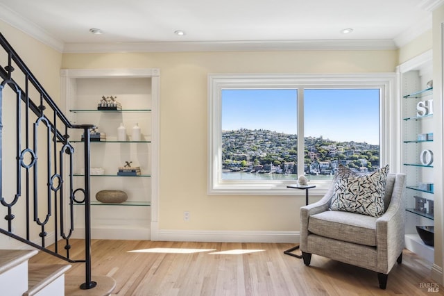 sitting room featuring ornamental molding, plenty of natural light, and light hardwood / wood-style flooring