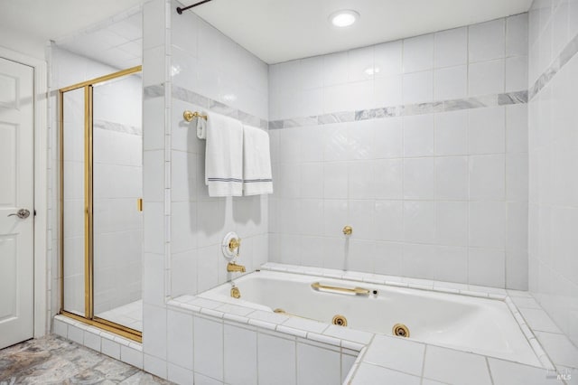 bathroom with tile flooring and shower with separate bathtub