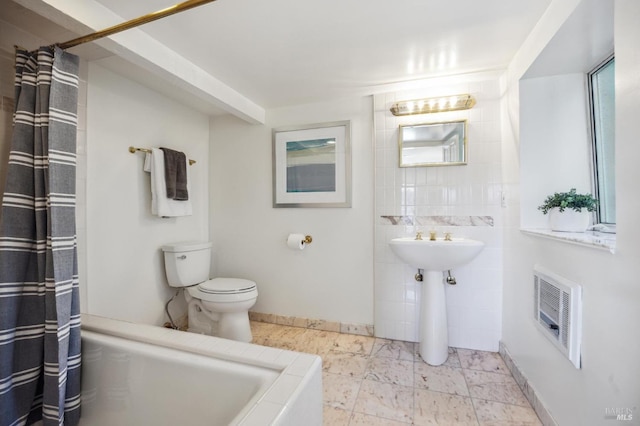 bathroom with tile floors, shower / bathtub combination with curtain, and toilet