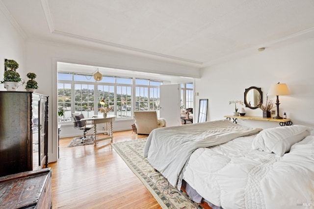 bedroom featuring light hardwood / wood-style floors and crown molding