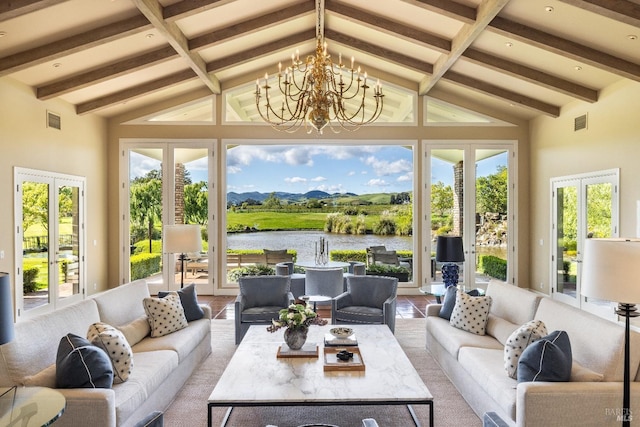 sunroom featuring an inviting chandelier, a water view, lofted ceiling with beams, and a wealth of natural light