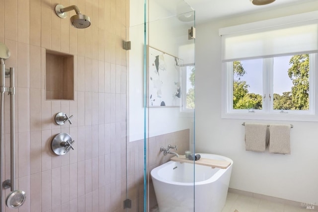 bathroom featuring shower with separate bathtub