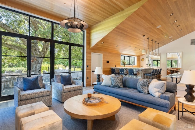 living room with high vaulted ceiling, wooden ceiling, and wood walls