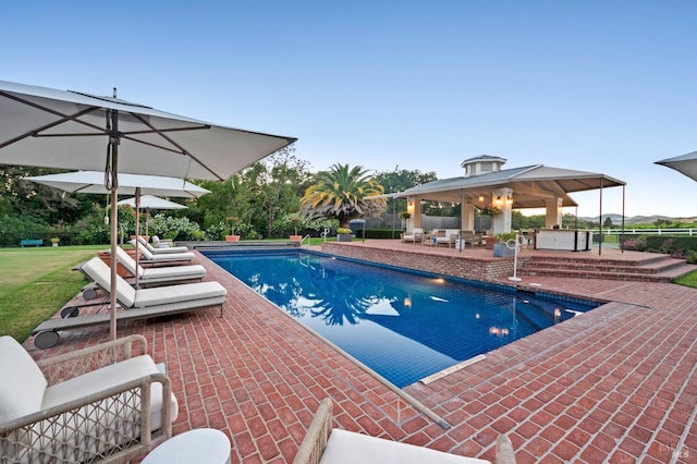 view of pool with an outdoor living space, a gazebo, a jacuzzi, and a patio