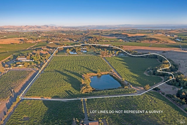 birds eye view of property with a rural view and a water view