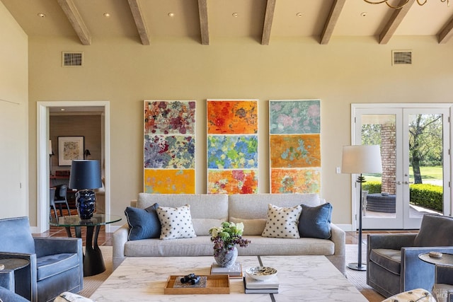 living room with beam ceiling and french doors