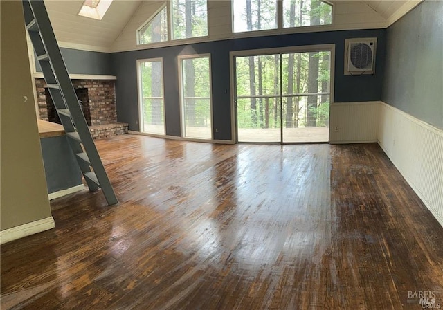 unfurnished living room featuring a skylight, high vaulted ceiling, dark hardwood / wood-style floors, and a brick fireplace