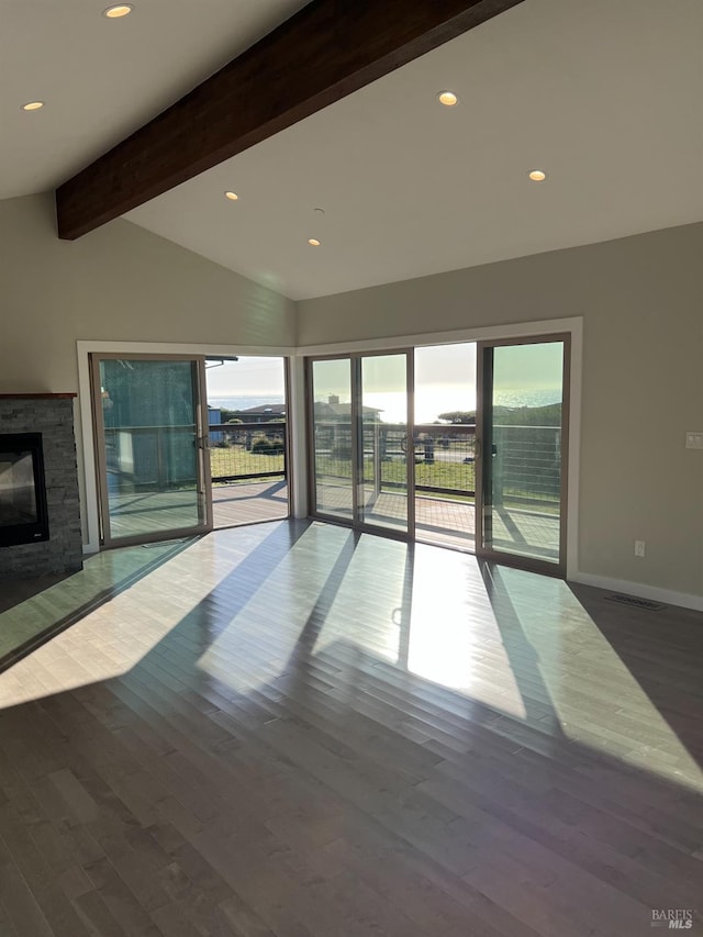 unfurnished living room featuring high vaulted ceiling, dark hardwood / wood-style flooring, a stone fireplace, and beam ceiling