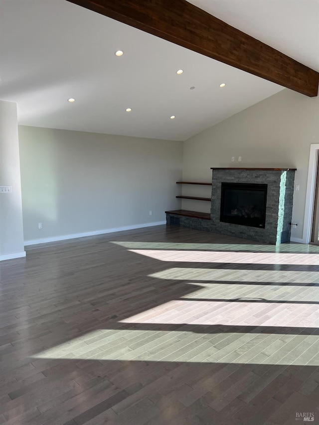 unfurnished living room with dark hardwood / wood-style floors and vaulted ceiling with beams