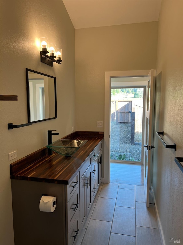 bathroom with tile floors and vanity