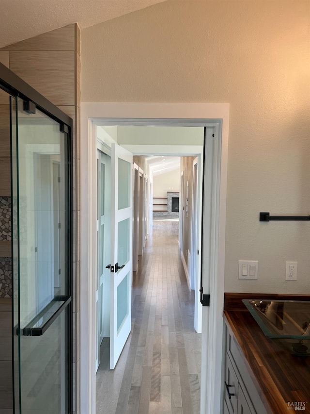 bathroom with wood-type flooring and lofted ceiling