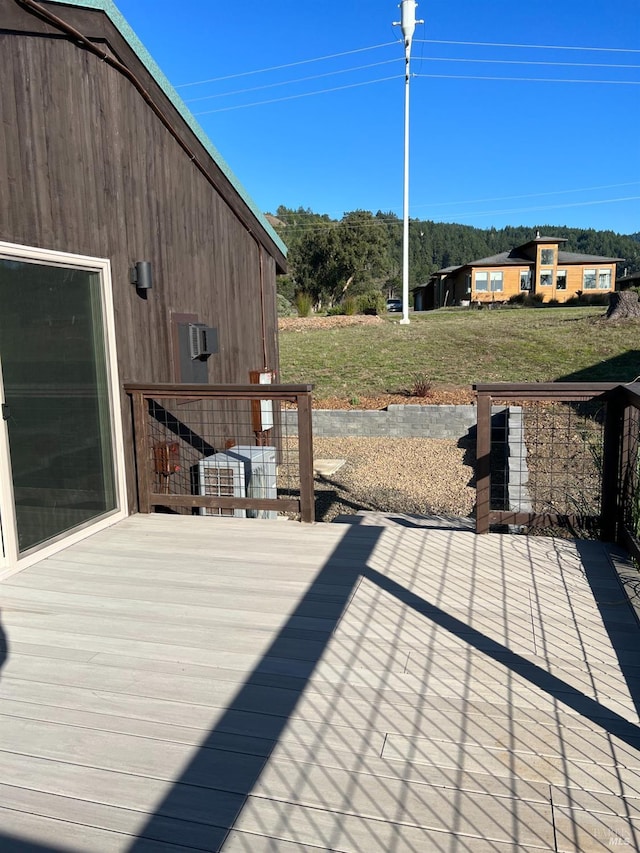 wooden deck featuring a yard