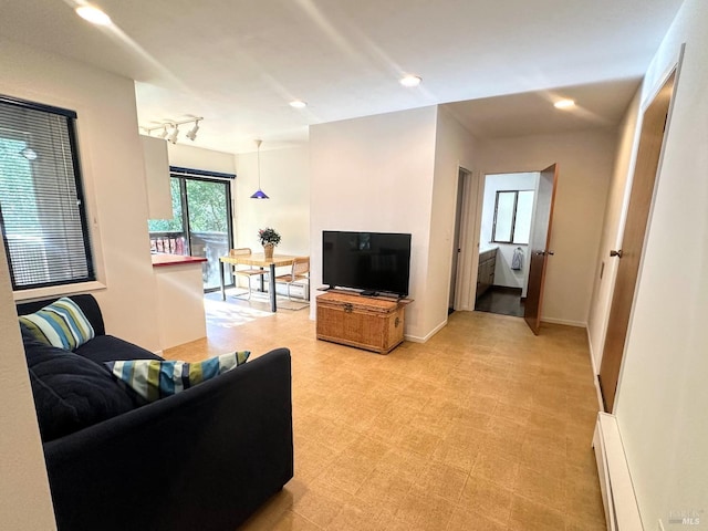 living room featuring baseboard heating and rail lighting