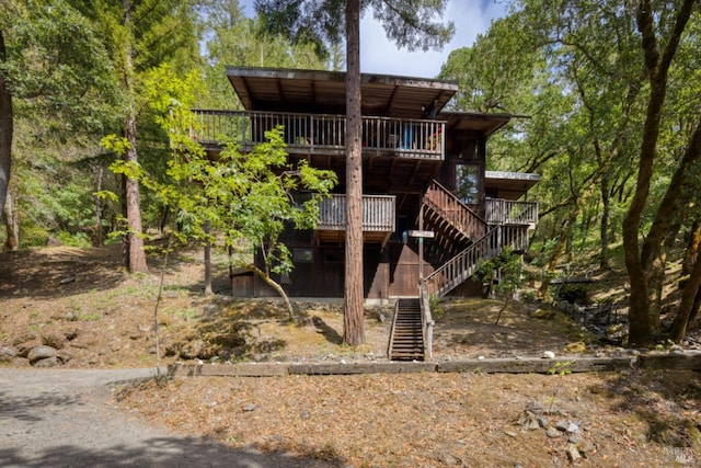 rear view of property featuring a deck