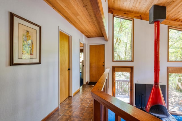 hallway with a wealth of natural light and wood ceiling