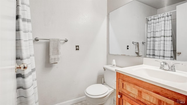 bathroom with toilet and large vanity