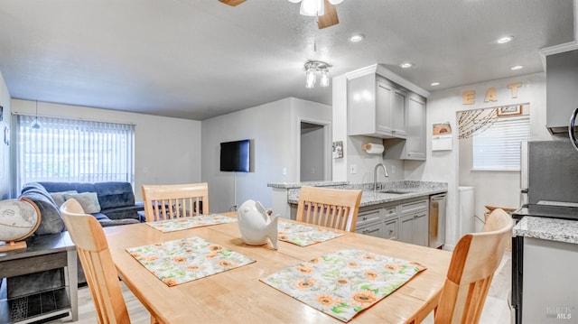 interior space with sink, wood-type flooring, ceiling fan, and a textured ceiling