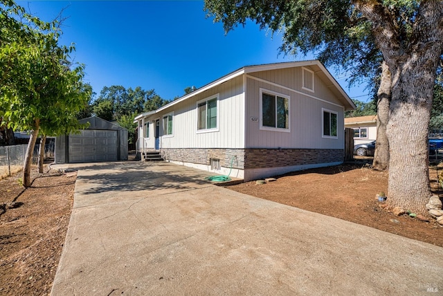 view of home's exterior with a garage and an outbuilding