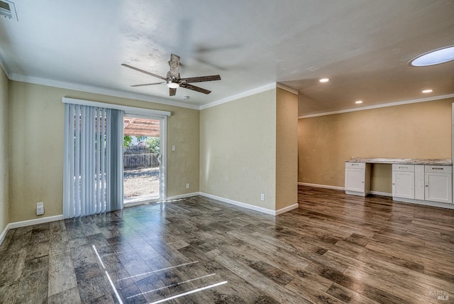 empty room featuring crown molding, dark wood-type flooring, and ceiling fan